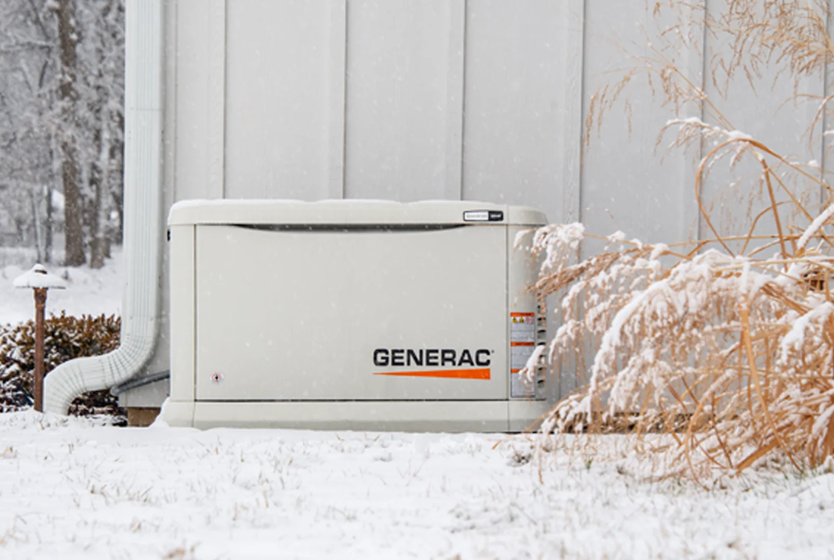 Standby generators outside a home in snow