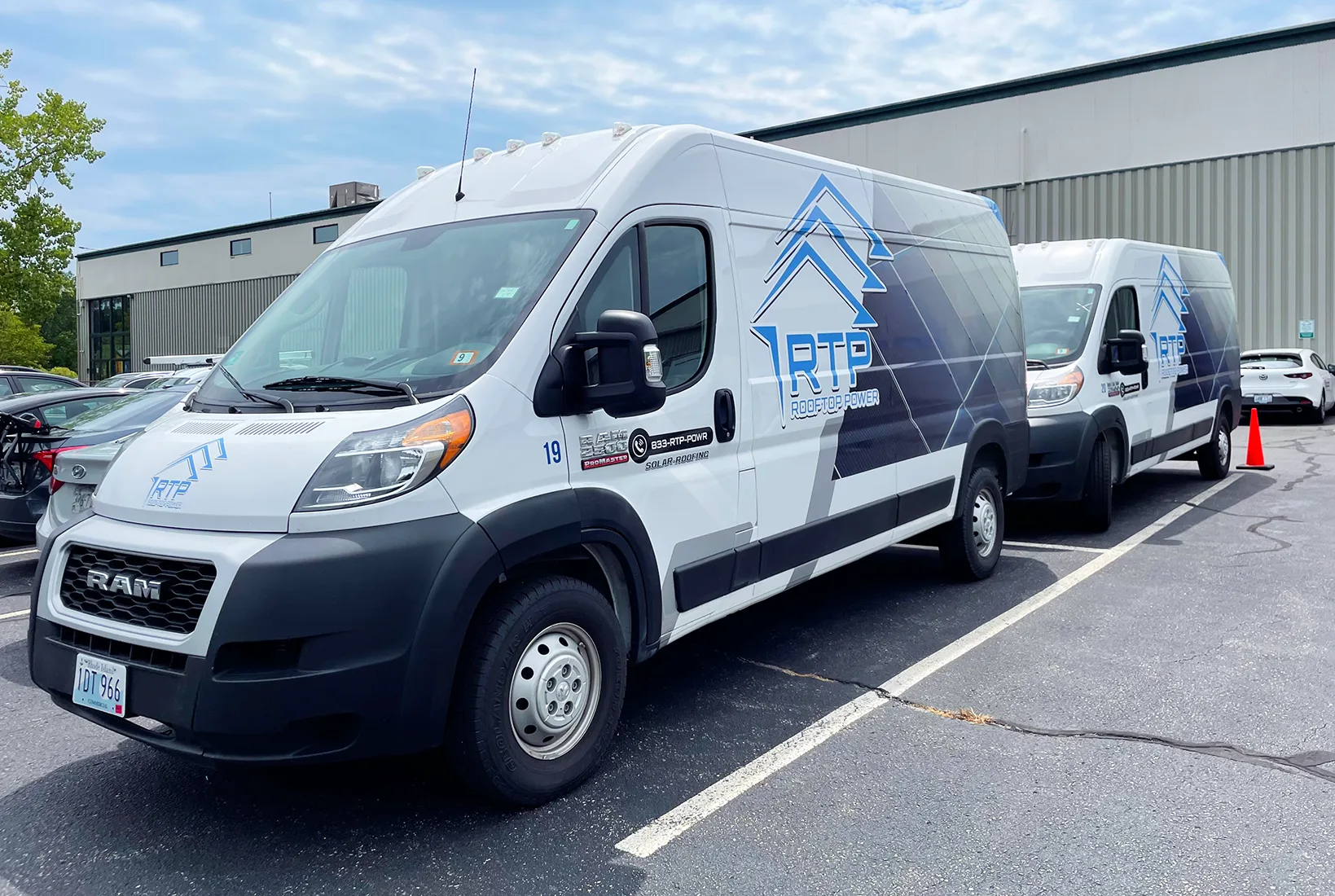Rooftop Power service vans parked with installation crews