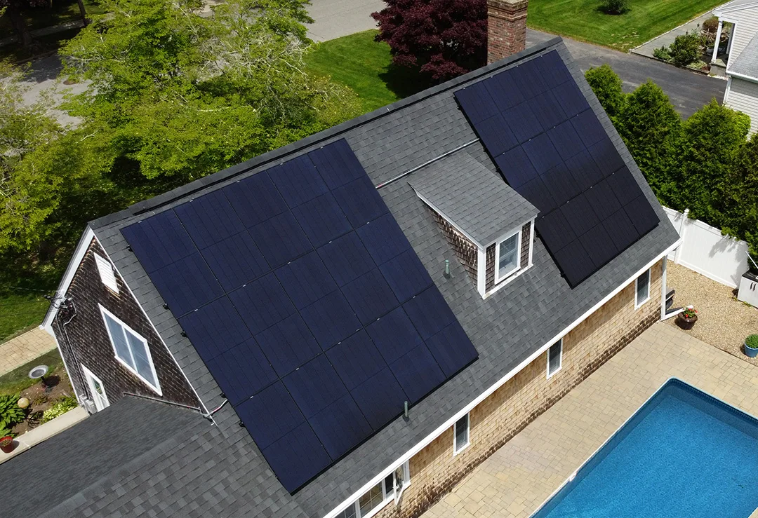 Rooftop solar array on a home with a backyard pool