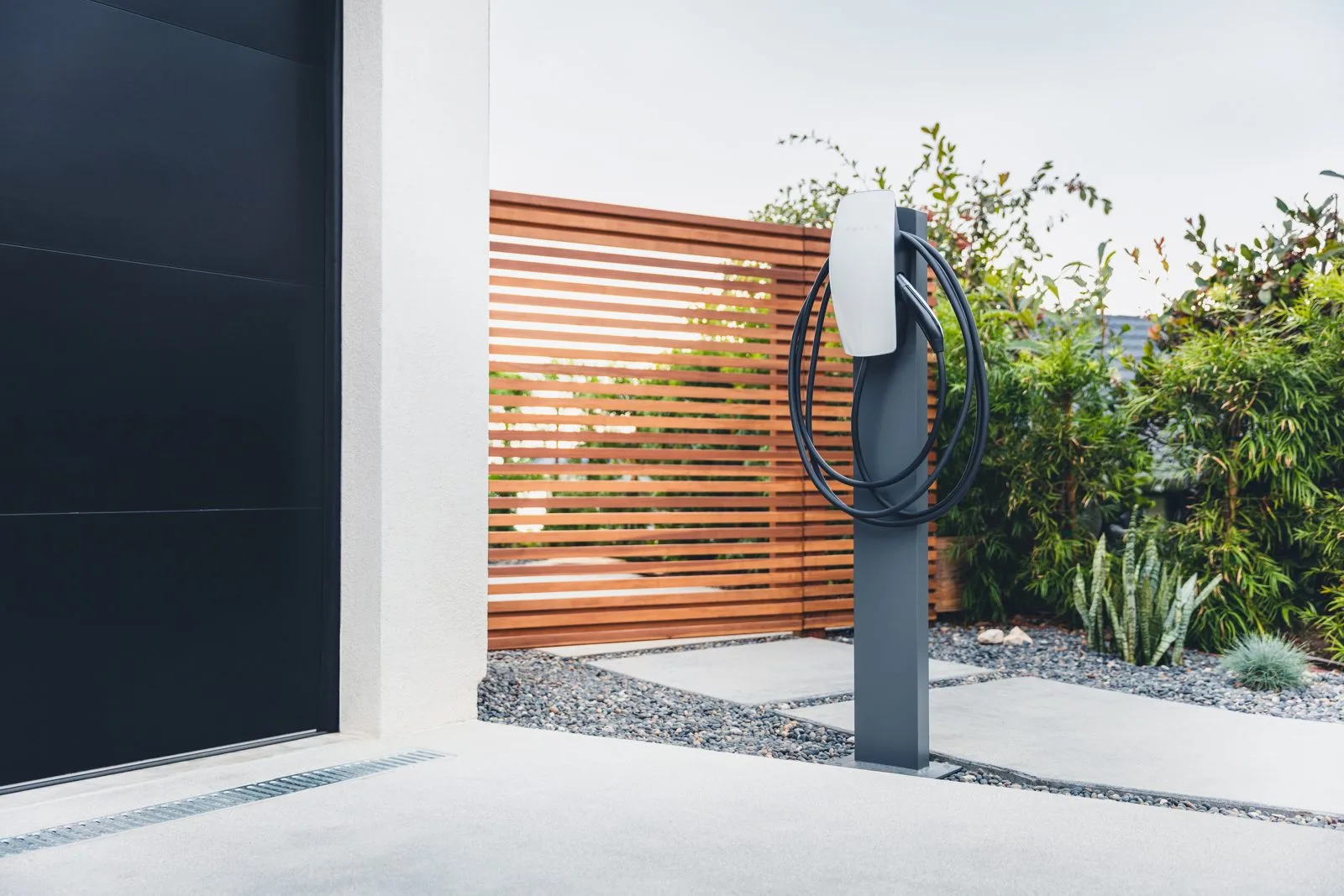 Tesla Wall Connector home EV charger mounted on a pedestal