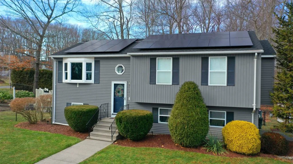 All-black Rooftop Power solar panels on a grey raised ranch