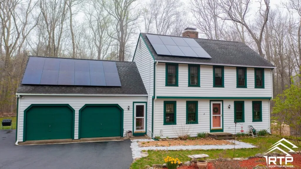 Rooftop Power solar on a white colonial home and its garage