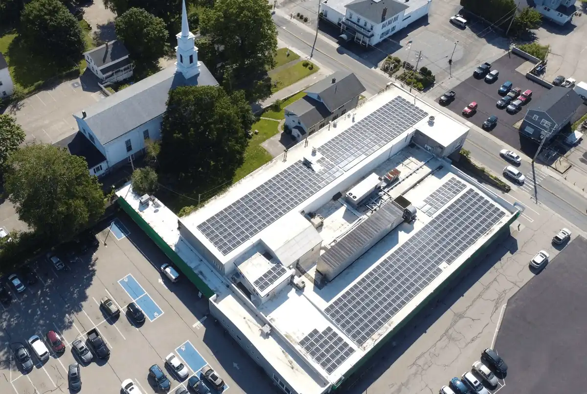 Commercial building with rooftop solar panels, aerial view
