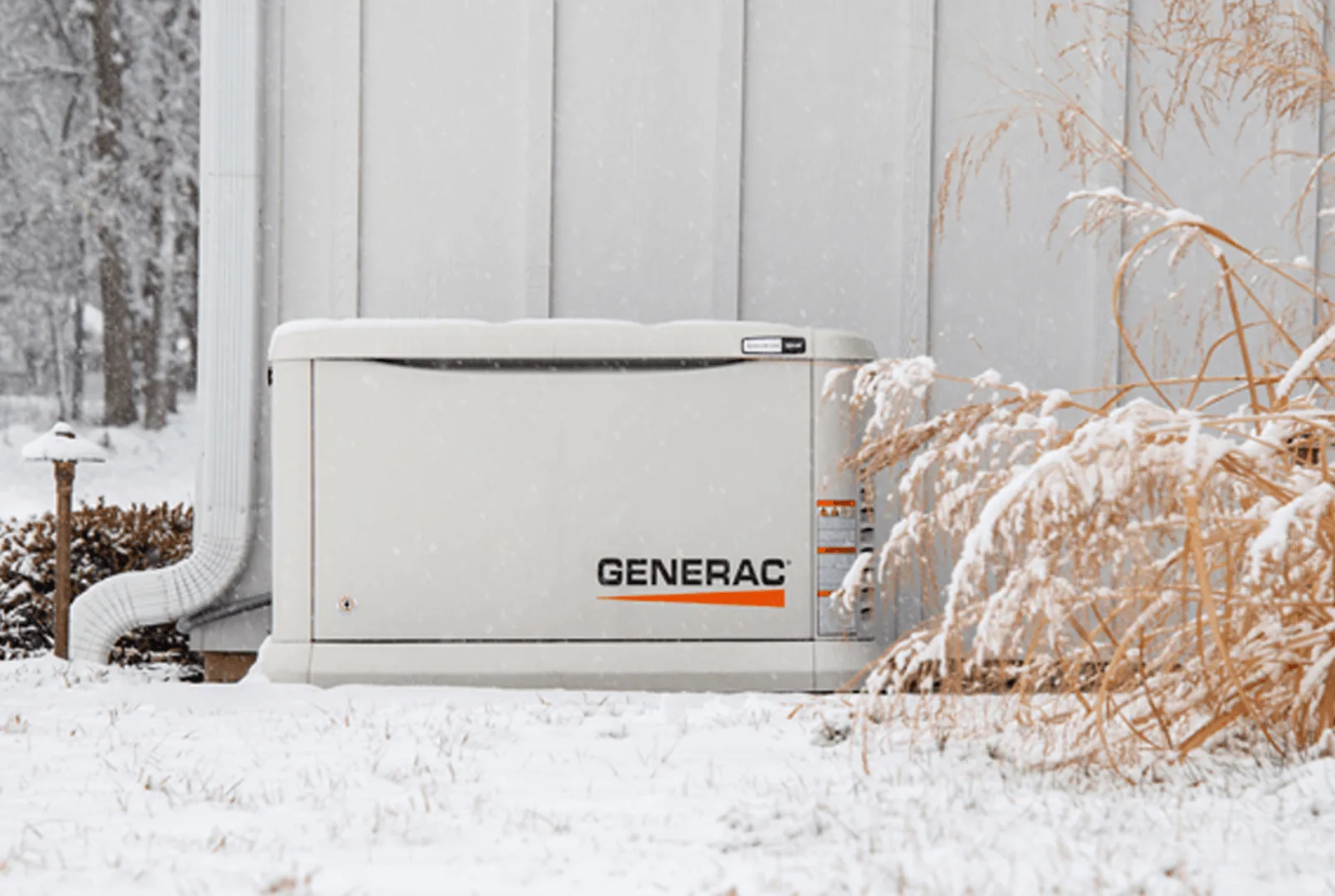 Standby generators outside a home in snow
