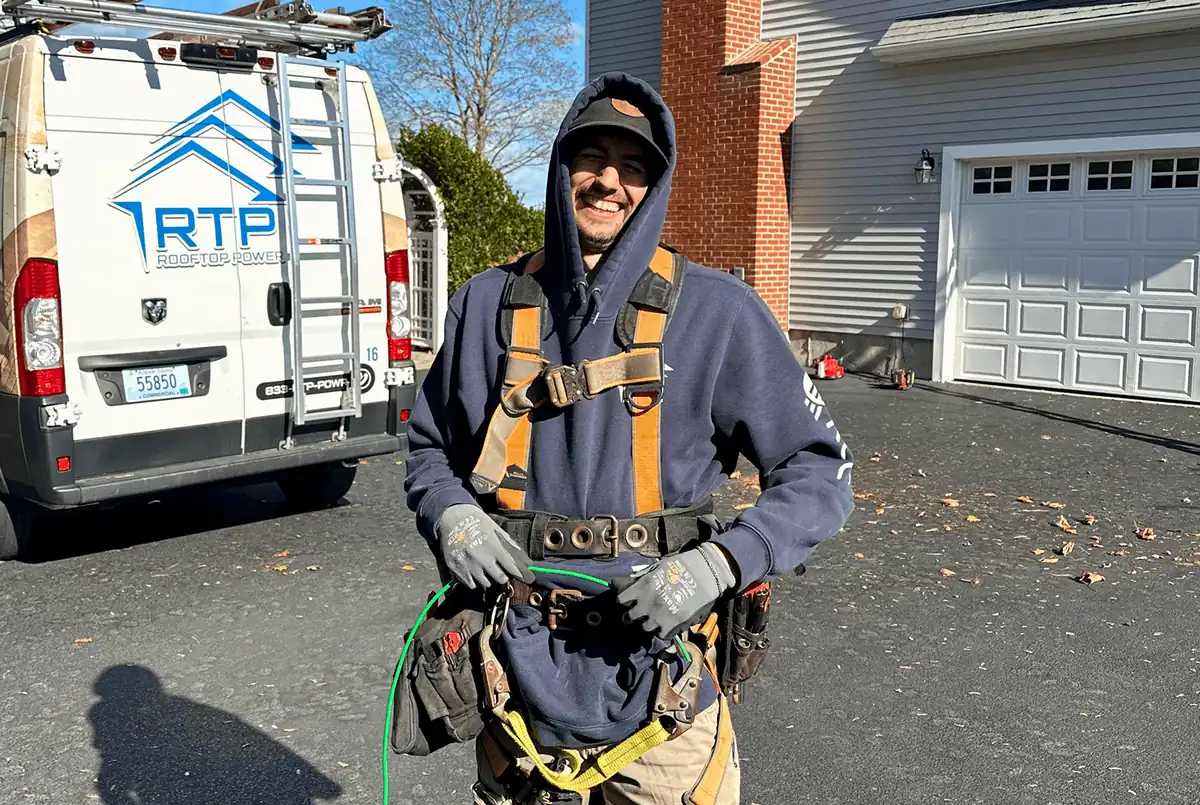 Technician removing and reinstalling solar panels on a roof