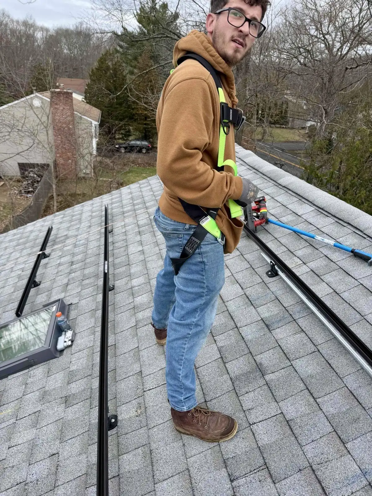 Rooftop Power installer working on a New England roof replacement